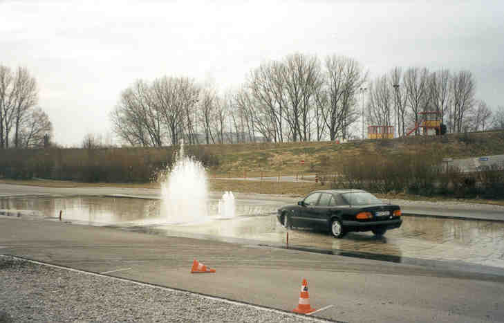 Skid control driver training on a wet surface with water fountain