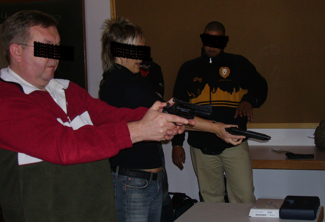 Practical shooting training during the firearms proficiency course, faces obscured for discretion